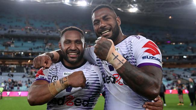 Storm centre Justin Olam with rugby-bound teammate Suliasi Vunivalu after winning the NRL grand final