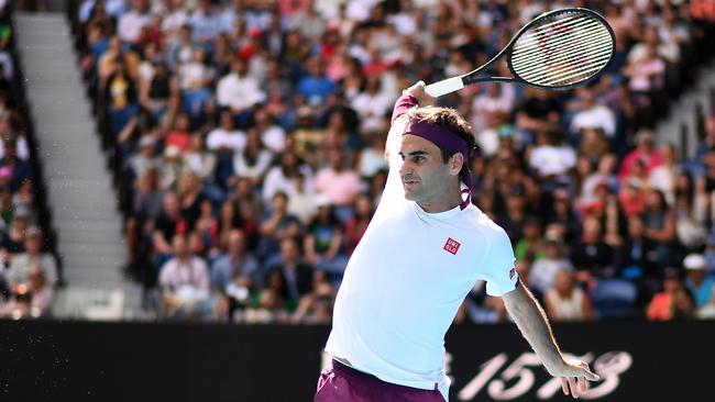 Switzerland's Roger Federer hits a return against Tennys Sandgren of the US