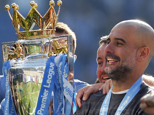 Manchester City coach Pep Guardiola lifts the English Premier League trophy after the English Premier League soccer match between Brighton and Manchester City at the AMEX Stadium in Brighton, England, Sunday, May 12, 2019. Manchester City defeated Brighton 4-1 to win the championship. (AP Photo/Frank Augstein)