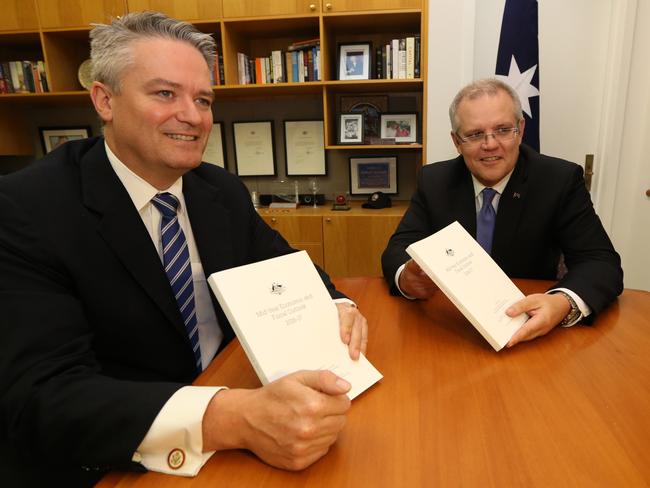 The Treasurer Scott Morrison with Mathias Cormann show the media the MYEFO document at Parliament House in Canberra. Picture: Gary Ramage