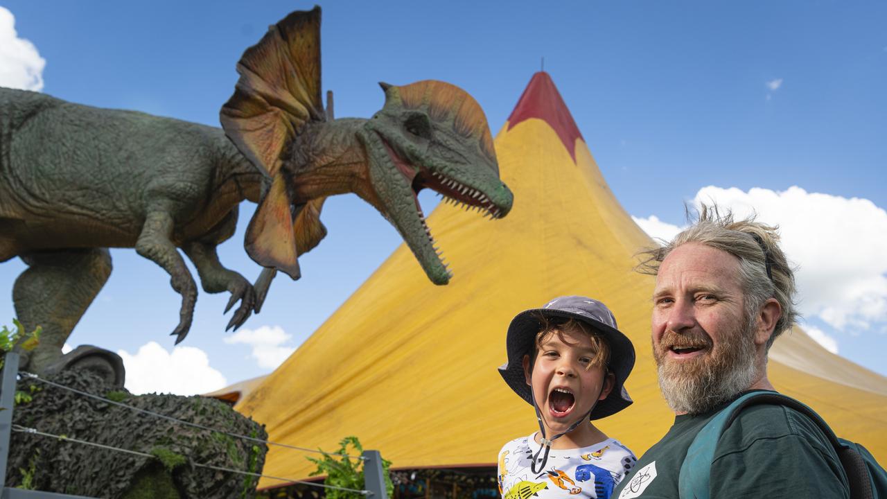 Tim (left) and Lockwood Allmand check out the Jurassic Creatures dinosaur exhibit in Toowoomba's Queens Park, Thursday, January 16, 2025. Picture: Kevin Farmer