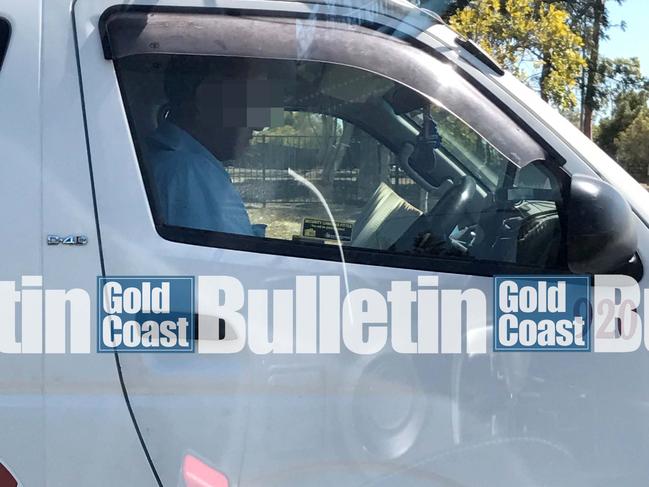 GCB Cab driver caught reading a book at lights. photo: supplied