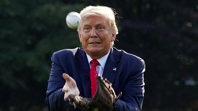 Donald Trump plays ball while hosting youth baseball players at the White House for the opening day of Major League Baseball on Friday AEST. Picture: Reuters