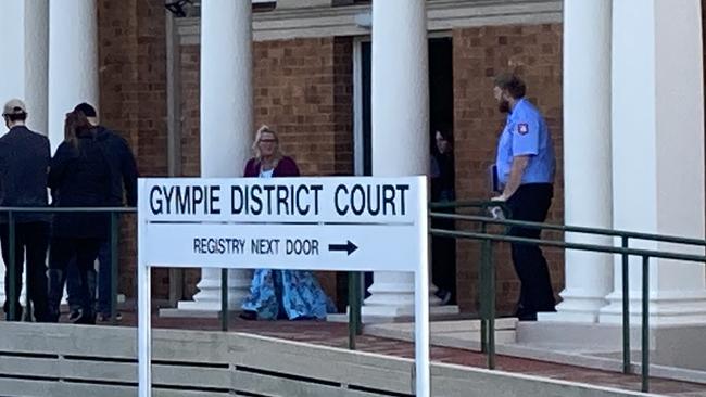 Kay Lorraine Menzies (maroon jumper) leaves Gympie District Court on Monday surrounded by family and friends.