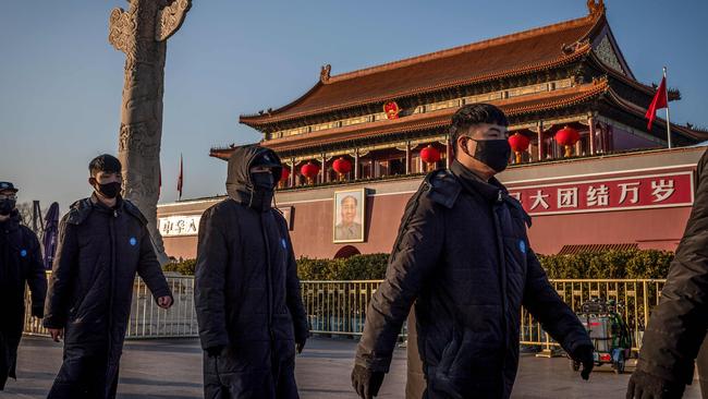 Security officers mask up at Tiananmen Gate in Beijing on Thursday. Picture: AFP