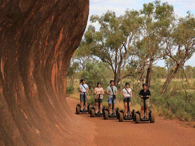 SEGWAY I lean back, and like magic I glide to a smooth stop at the base of the Uluru climb. We’ve traversed the 9.5 kilometre circumference of Uluru by Segway, an ingenious and intuitive mode of transport for a destination like this. Battery powered and fairly quiet, we zip past all manner of walkers, cyclists and joggers with the grace of those who’ve had 15 minutes training. Fortunately, our guides from Uluru Segway Tours taught us everything they know. At the climb point, thrillseekers trudge past a large sign imploring people not to climb. There are a few up there today, uncomfortably bent over to thigh-height, but it’s not massively busy. Most of the tourists are on the ground, taking in the sight of the monolith. Picture: Voyages Indigenous Tourism Australia