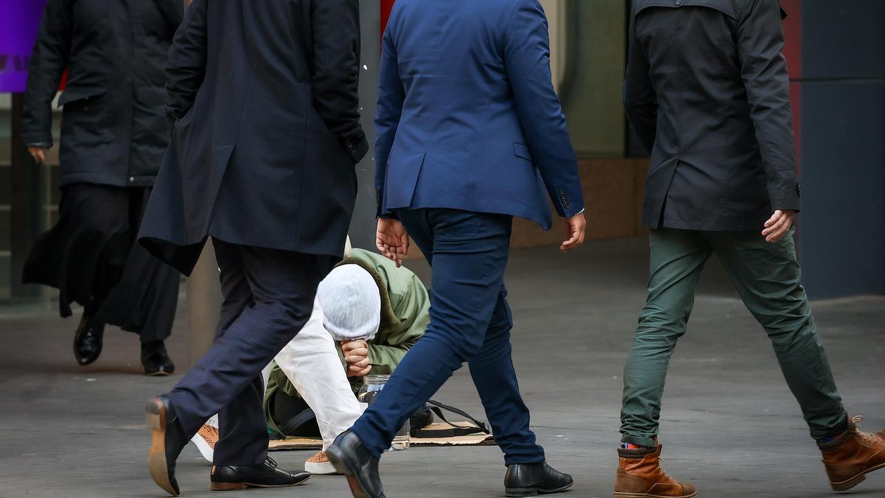 A man begs for money on Elizabeth Street in Melbourne on Thursday. Picture: NCA NewsWire / Ian Currie