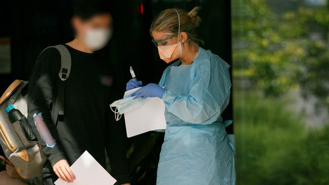 Patient in mask been seen by triage nurse at Northern Beaches Hospital's new COVID-19 clinic. Picture: Tim Pascoe