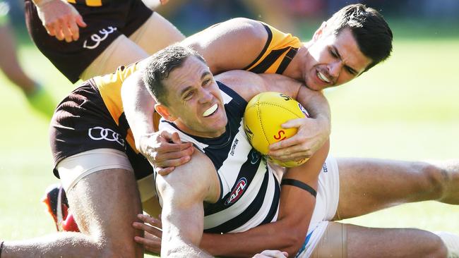 Geelong captain Joel Selwood receives a free kick after lowering his body and being tackled high by Hawk Ryan Burton. Picture: Getty Images