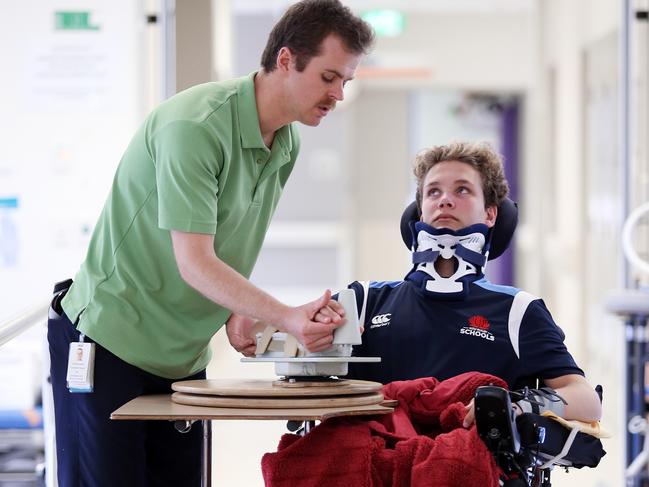 Alex with occupational therapist Christian Minett. Picture: Sam Ruttyn