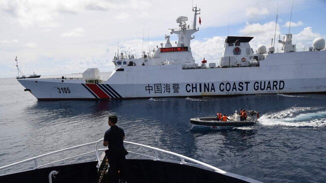 A Chinese coast guard ship blocking a Philippine Bureau of Fisheries and Aquatic Resources boat in the disputed South China Sea. Picture: AFP/Getty Images