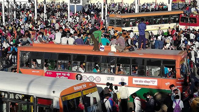 Migrant workers and their family members gather outside the Anand Vihar bus terminal to leave for their villages. Picture: Bhuvan Bagga/AFP