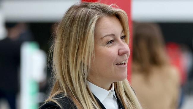 SYDNEY, AUSTRALIA - NewsWire Photos JULY 1, 2022: Qantas executive Olivia Wirth pictured helping people check in at T3 Qantas Domestic departures terminal at Sydney Airport ahead of the Winter School Holidays.Picture: NCA NewsWire / Damian Shaw