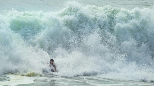 A bodysurfer at Coolum as Ex-tropical Cyclone Seth makes its way down South East Queensland. Picture: Lachie Millard.