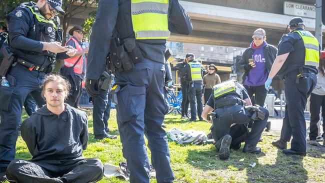 Police confront and arrest anti-war activists attempting to disrupt the Land Forces 2024 Expo at the Melbourne Convention and Exhibition Centre. Picture: Jake Nowakowski