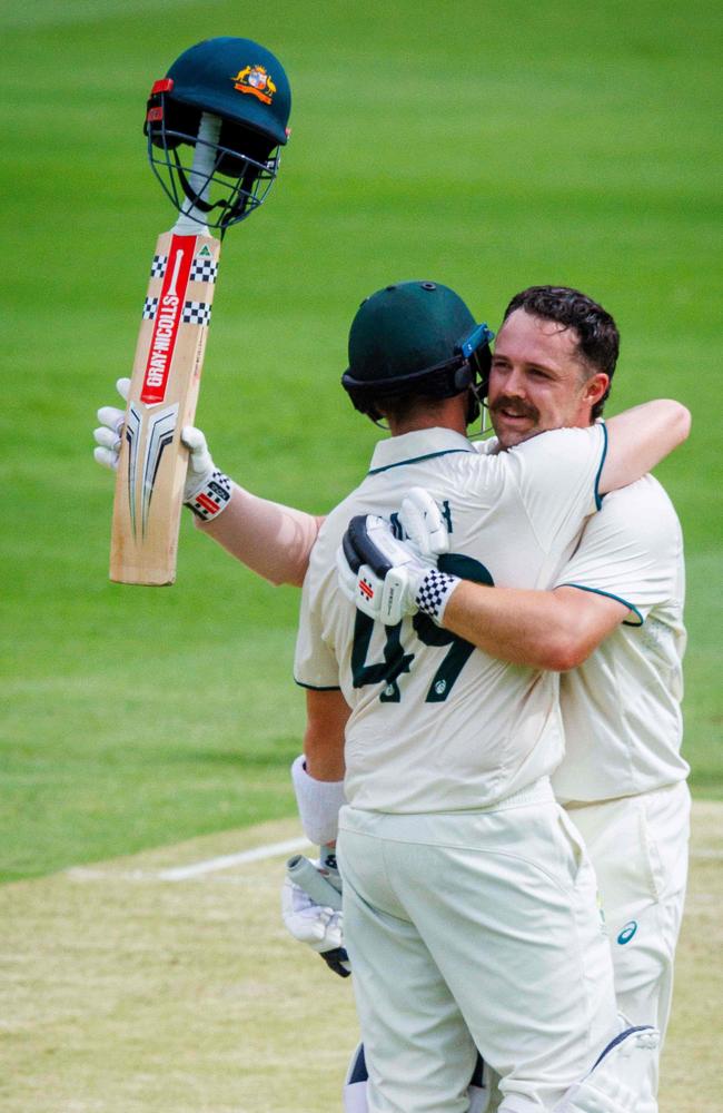 Australia's Travis Head celebrates reaching his century with Steve Smith. Picture: Patrick Hamilton/AFP.