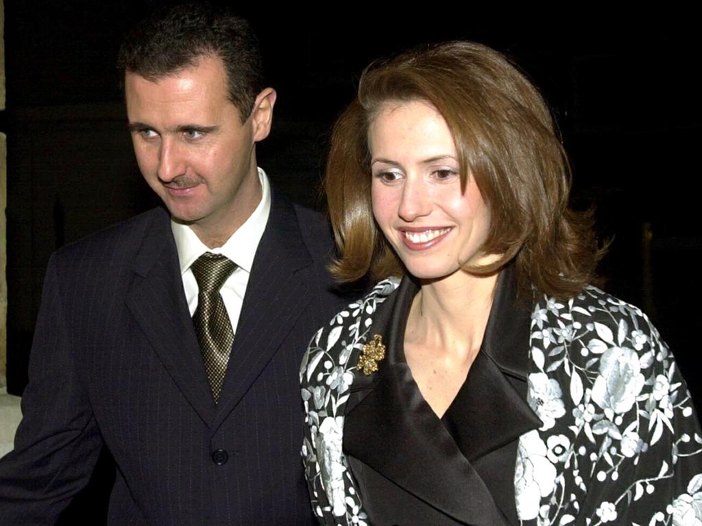 Syrian ousted president Bashar al-Assad and his wife Asma arrive for a dinner hosted by Britain's Lord Chancellor, Lord Irvine of Lairg, at Lancaster house in central London 16 December 2002. (Photo by NICOLAS ASFOURI / POOL / AFP)