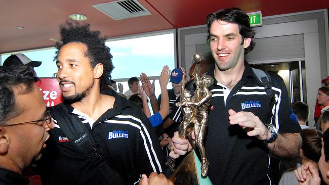 Bruton and Sam Mackinnon carry the trophy through Brisbane Airport after winning the title in 2007.