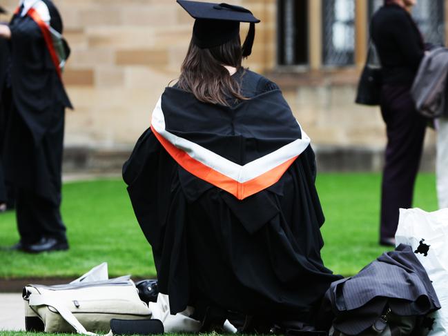 University students wearing their graduation mortar board hats and gowns for their graduation ceremony on campus at Sydney University in Sydney.