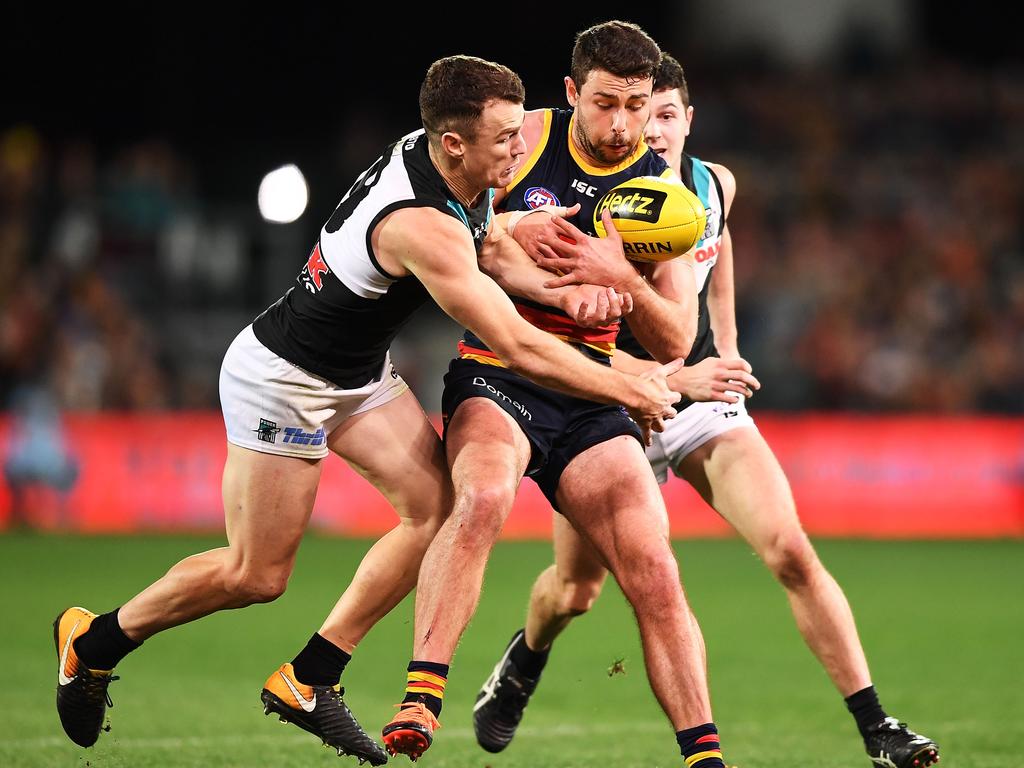 ADELAIDE, AUSTRALIA - AUGUST 04: Robbie Gray of Port Adelaide tackles Rory Atkins of the Adelaide Crows  during the round 20 AFL match between the Adelaide Crows and the Port Adelaide Power at Adelaide Oval on August 4, 2018 in Adelaide, Australia.  (Photo by Mark Brake/Getty Images)