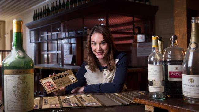 Renew Adelaide's Lily Jacobs with old bottles and drink menu cards from the old Chesser Cellar restaurant. Pic: Matt Turner