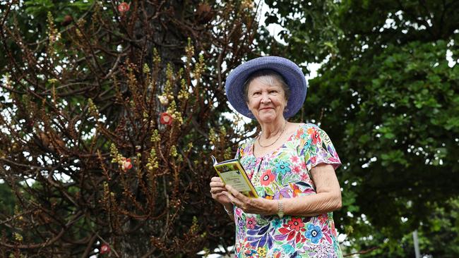 Cairns botany enthusiast Fran Clayton is marking 20 years since her book The Fabulous Flowering Tree of Cairns City: A Walking Guide was published, with Cairns Regional Council planting a tree on the Cairns Esplaande to mark the occassion. Fran Clayton admires a cannonball tree as it flowers and fruits on the Cairns Esplanade. Picture: Brendan Radke