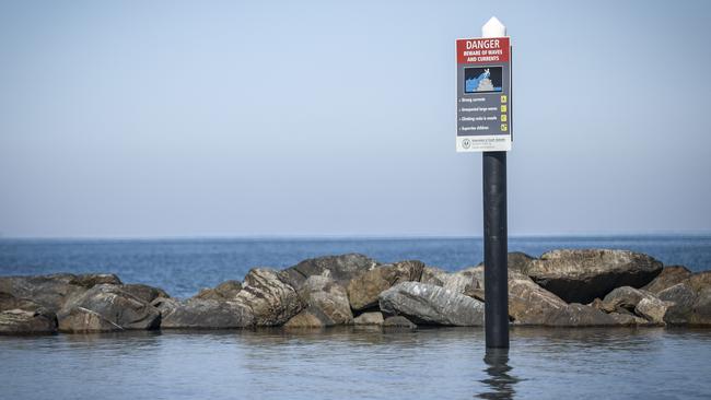 A warning sign at the Glenelg breakwater. Picture: Mike Burton/AAP