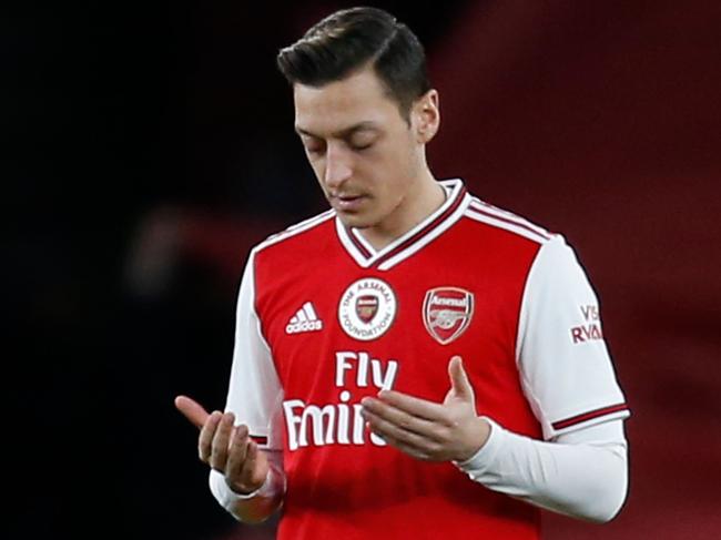 Arsenal's German midfielder Mesut Ozil gestures before kick off in the English Premier League football match between Arsenal and Manchester City at the Emirates Stadium in London on December 15, 2019. (Photo by Ian KINGTON / IKIMAGES / AFP) / RESTRICTED TO EDITORIAL USE. No use with unauthorized audio, video, data, fixture lists, club/league logos or 'live' services. Online in-match use limited to 45 images, no video emulation. No use in betting, games or single club/league/player publications.