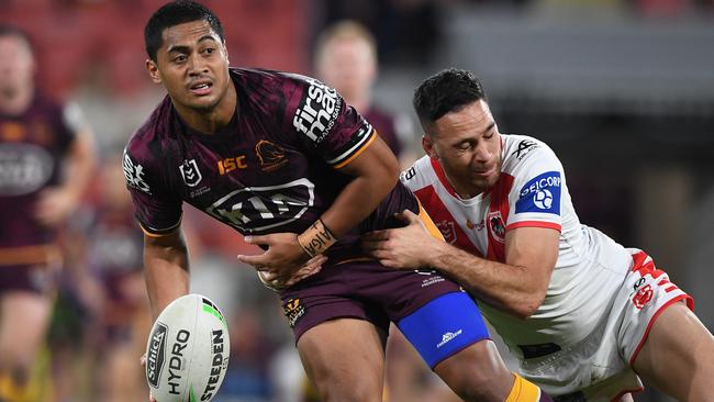 Anthony Milford is tackled by Corey Norman during the round 15 NRL match between the Brisbane Broncos and the St George Illawarra Dragons at Suncorp Stadium on August 21. Picture: Getty Images