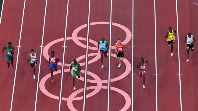 From L: Brazil's Felipe Bardi Dos Santos, Britain's Zharnel Hughes, USA's Trayvon Bromell, Nigeria's Enoch Adegoke, Bahamas's Samson Colebrooke, Switzerland's Silvan Wicki, Qatar's Femi Ogunode, Guyana's Emanuel Archibald and Refugee Olympic Team's Dorian Keletela compete in the men's 100m heats during the Tokyo 2020 Olympic Games at the Olympic Stadium in Tokyo on July 31, 2021. (Photo by Antonin THUILLIER / AFP)