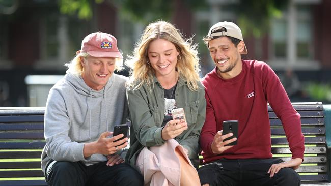 Callum Sadberry, Claudia Talon and Florian Sohier check their phones. Picture: Alex Coppel.