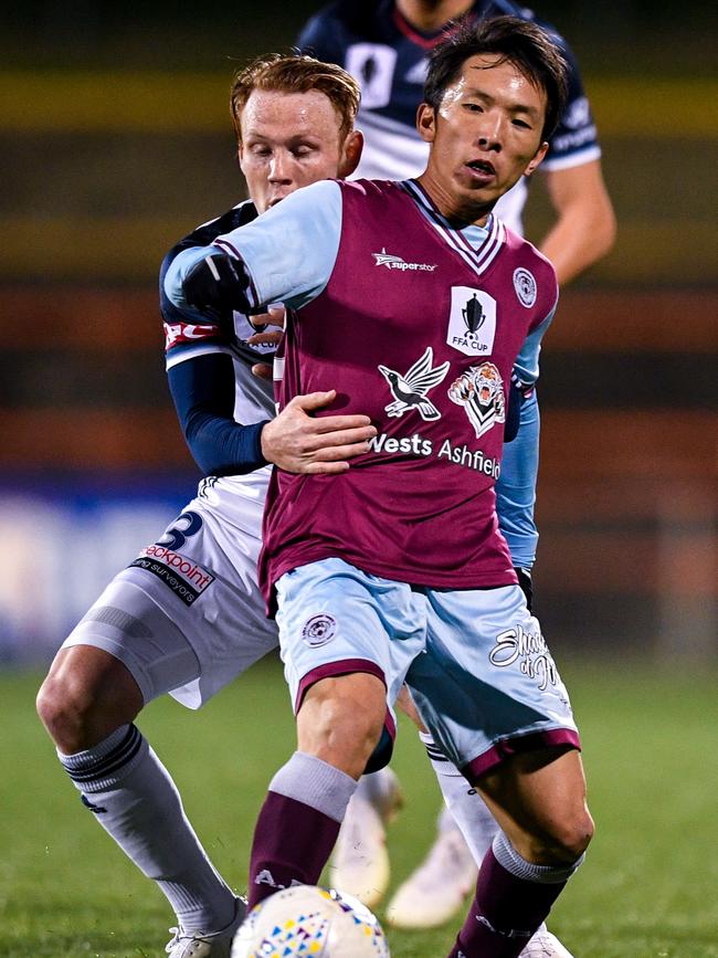 Tasuku Sekiya vies with Melbourne Victory’s Corey Brown for possession. 