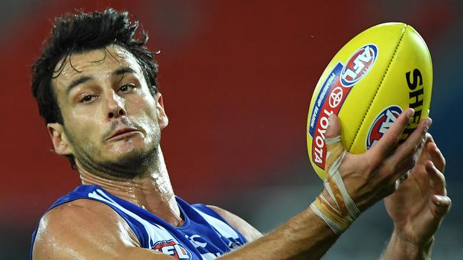 GOLD COAST, AUSTRALIA - SEPTEMBER 05: Robbie Tarrant of the Kangaroos handballs during the round 16 AFL match between the North Melbourne Kangaroos and the Port Adelaide Power at Metricon Stadium on September 05, 2020 in Gold Coast, Australia. (Photo by Matt Roberts/AFL Photos/via Getty Images)