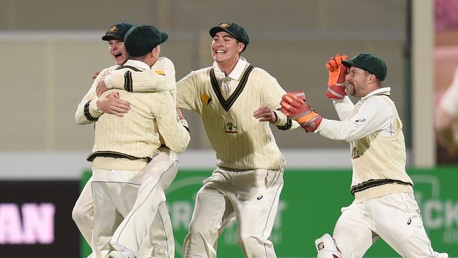 Australian captain Steve Smith celebrates with Peter Handscomb following South African batsman Faf du Plessis dismissal at the Adelaide Oval in 2016. Picture: AAP Image/Dave Hunt. 