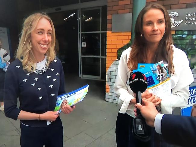 Liberal Pittwater by-election candidate Georgia Ryburn (left) handing out how-to-vote pamphlets alongside community independent Jacqui Scruby at Mona Vale on Wednesday. Picture: 7News