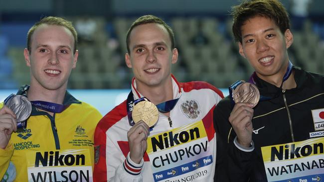 Gold medalist Russia's Anton Chupkov, centre, stands with silver medalist Australia's Matthew Wilson, left, and bronze medalist Japan's Ippei Watanabe. Picture: AP Photo/Mark Schiefelbein