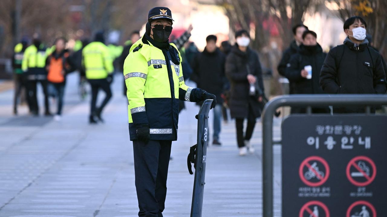 Policemen stand guard at Gwanghwamun Square in downtown Seoul on December 4, 2024, after martial law was lifted. Picutre: Jung Yeon-je/AFP