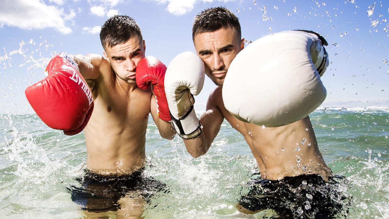 Boxing twins Andrew (left) and Jason Moloney in the surf on the Gold Coast. Picture: Nigel Hallett