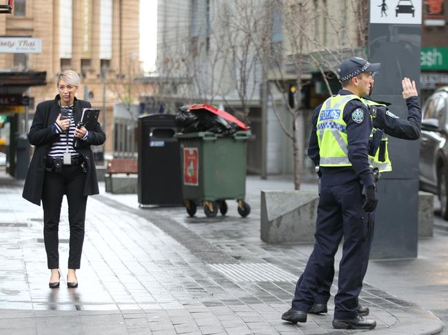 Police and detectives on Hindley St after a man was seriously assaulted. Picture: AAP / Dean Martin