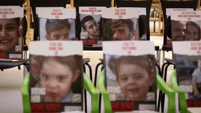 An installation consisting of chairs with books and portraits of Israeli hostages   at the new building of the National Library of Israel in Jerusalem. Picture: AFP.