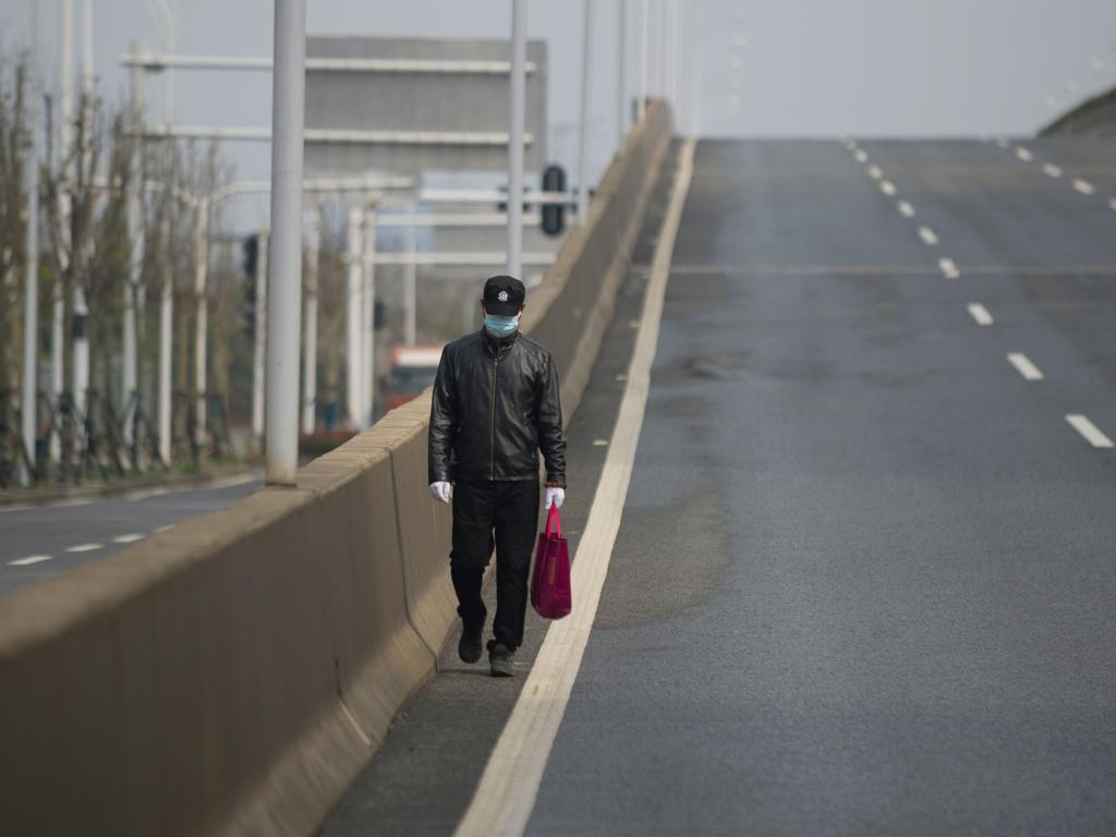 A man walks on an empty street in Wuhan, in China's central Hubei province. Picture: STR / AFP