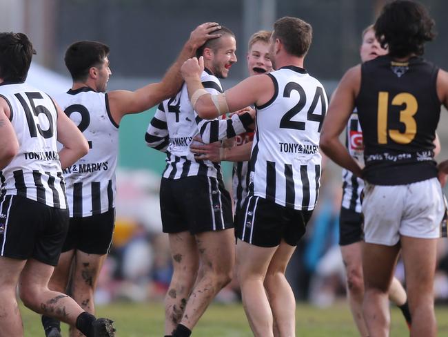 Adelaide Footy League, general action from on-field. Payneham Norwood Union vs Brighton at Payneham Oval. Payneham Norwood Union player, No.4, Jed Spence being congratulated by team mates, after kicking a goal.27 July 2024. Picture: Dean Martin