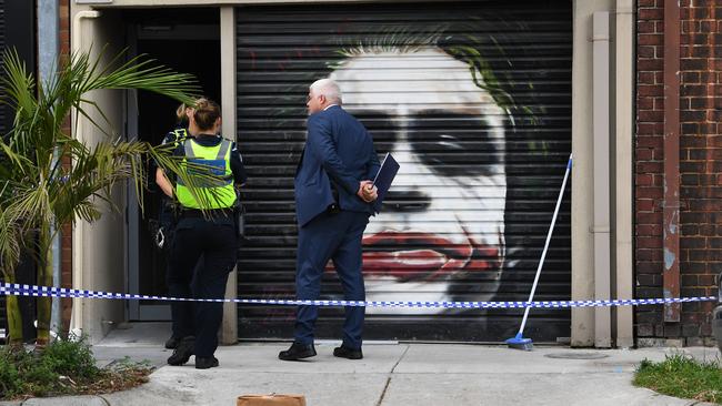 Victoria Police officers and detectives raid a property in Port Melbourne. Picture: AAP