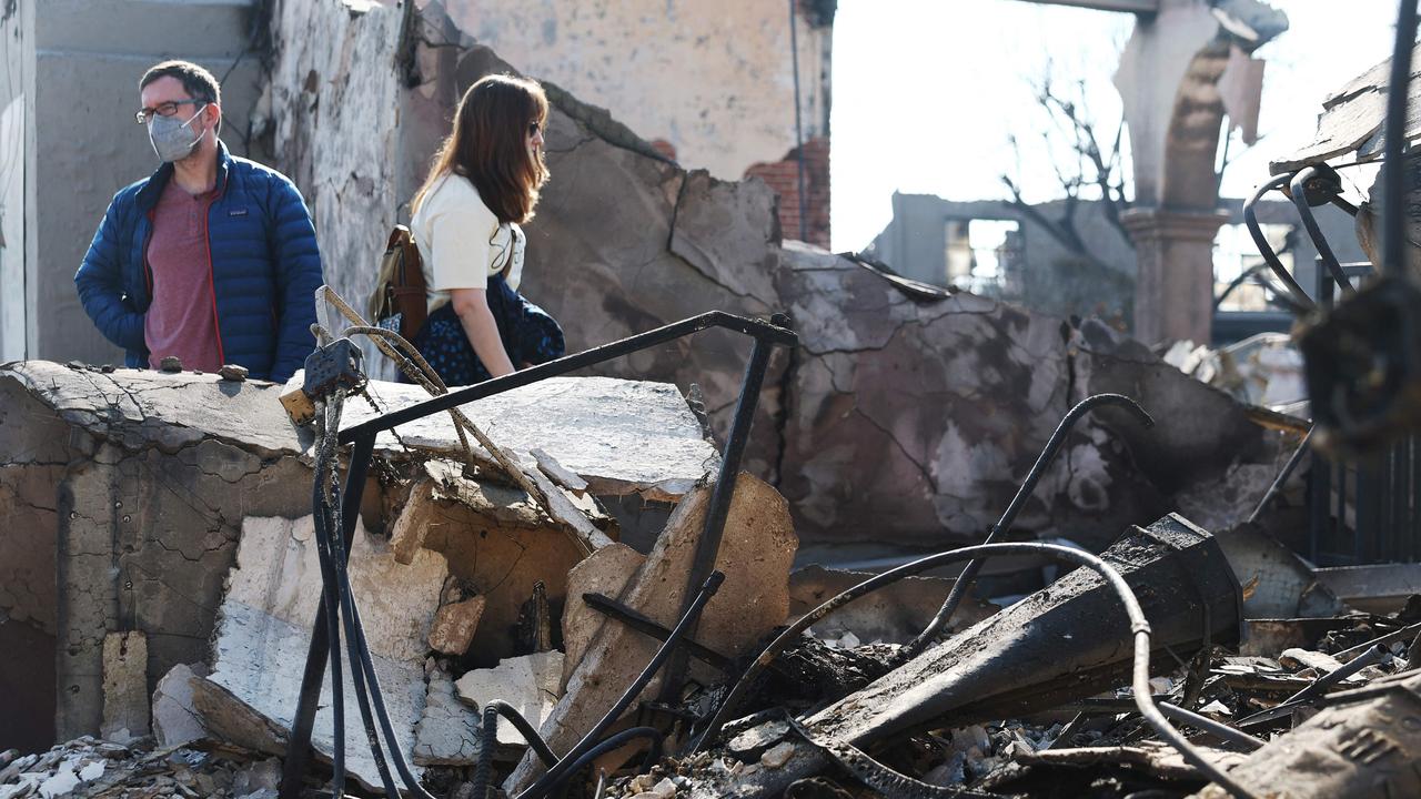 Congregants walk through the remains Pasadena Jewish Temple &amp; Center, which was destroyed in the Eaton Fire, as wildfires cause damage and loss through the LA region. Mario Tama/Getty Images/AFP