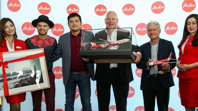 Flanked by hostesses at the AirAsia X 10-year birthday at Q1's Skypoint in Surfers Paradise are (from left) Guy Sebastian (AirAsia brand ambassador), Benyamin Ismail (AirAsia X CEO), Paul Donovan (Executive General Manager Business Development and Marketing Queensland Airports Limited), Martin Winter (CEO of Gold Coast Tourism).