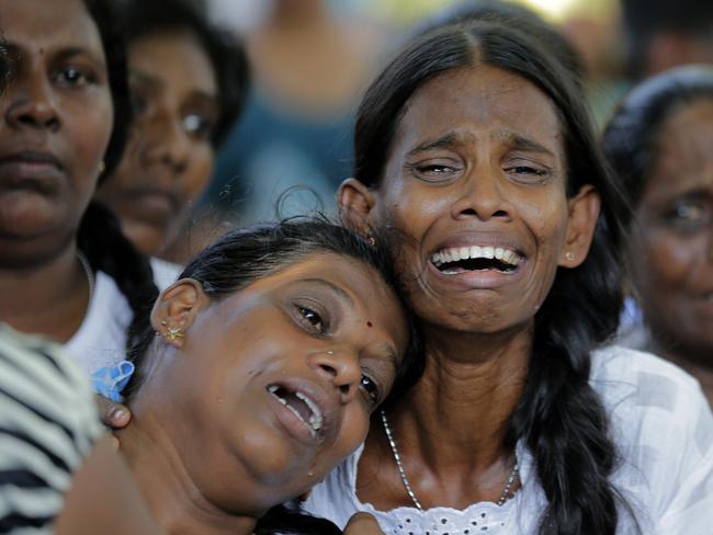 Relatives of the Burlington family weep during the funeral of their family members who were killed in the Easter Sunday bombings in Colombo. Picture: AFP 