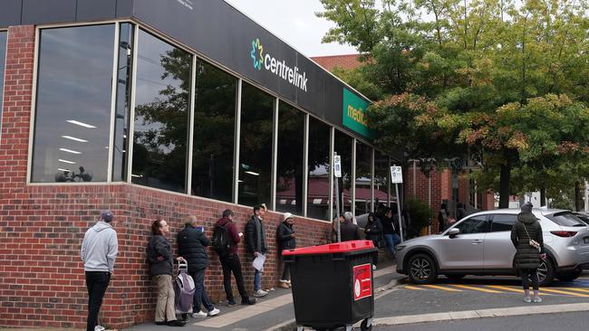 People queuing outside a yet-to-open Centrelink office in Heidelberg. Picture: AAP Image/Stefan Postles