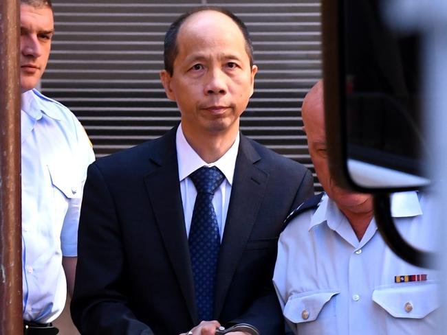 Robert Xie (centre) is escorted to a prison transport vehicle at the NSW Supreme Court in Sydney on Monday, Feb. 13, 2017. Lian Bin "Robert" Xie has been found quilty and been given five life sentences without the possibility of parole for the murder of five members of his wife's family in the bedrooms of their North Epping home in July 2009.(AAP Image/Paul Miller) NO ARCHIVING