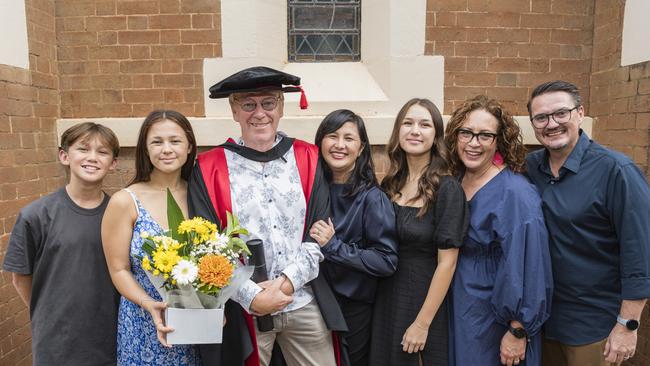 Doctor of Philosophy graduate Nick Todd with family and friends (from left) Daniel Todd, Sophie Todd, Kim Todd, Jodie Todd, Annelize Mulder and Coenraad Mulder at a UniSQ graduation ceremony at Empire Theatres, Tuesday, February 13, 2024. Picture: Kevin Farmer