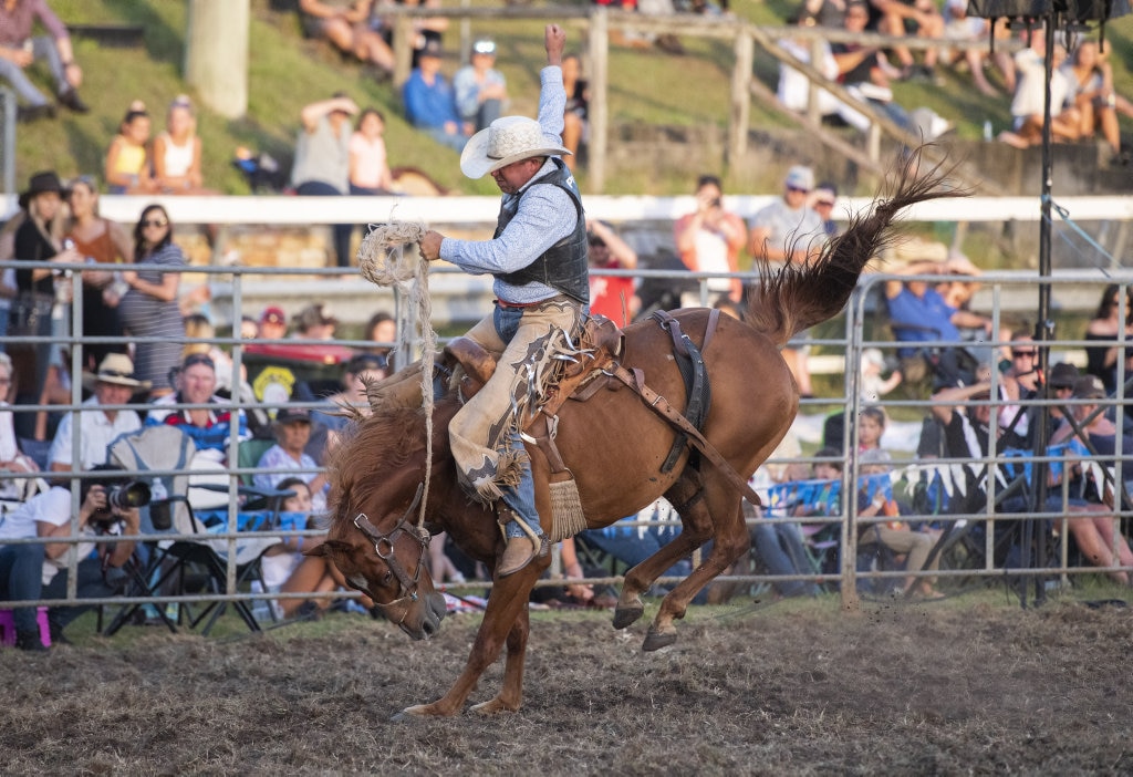 Josh Barnett rides high in the saddle bronc at the Lawrence Twilight Rodeo. Picture: Adam Hourigan